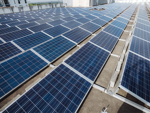 Commercial solar panels installed on a business rooftop by Sharp EIT