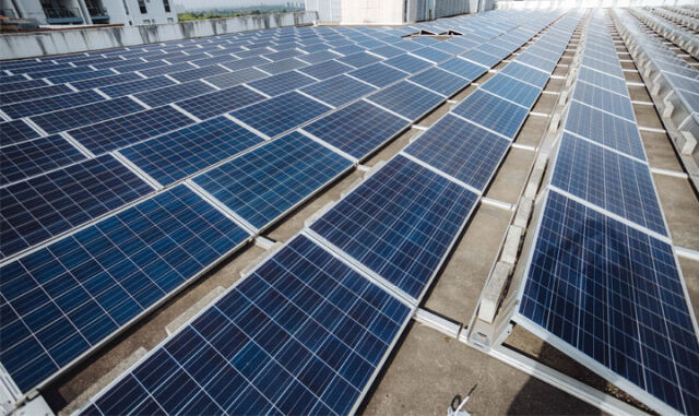 Commercial solar panels installed on a business rooftop by Sharp EIT