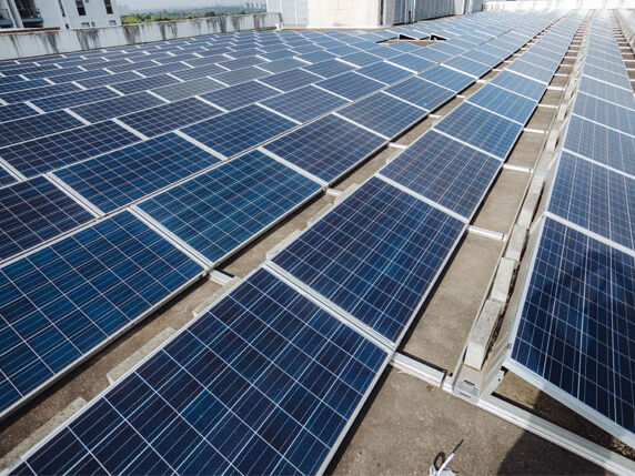 Commercial solar panels installed on a business rooftop by Sharp EIT