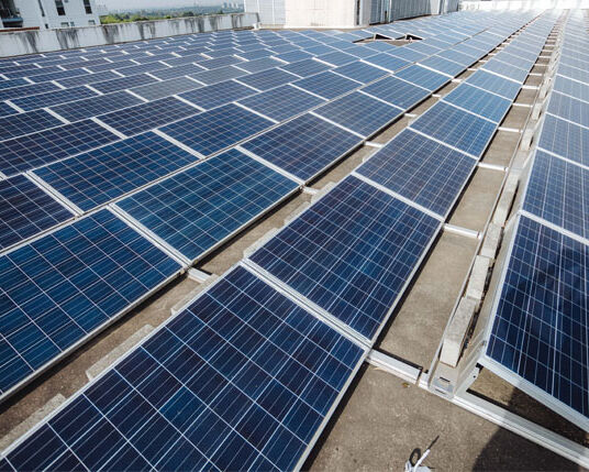 Commercial solar panels installed on a business rooftop by Sharp EIT