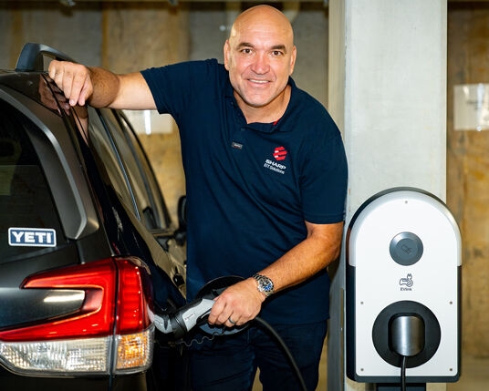 Gorden Tallis using a Sharp EIT commercial EV charger for business solar energy solutions